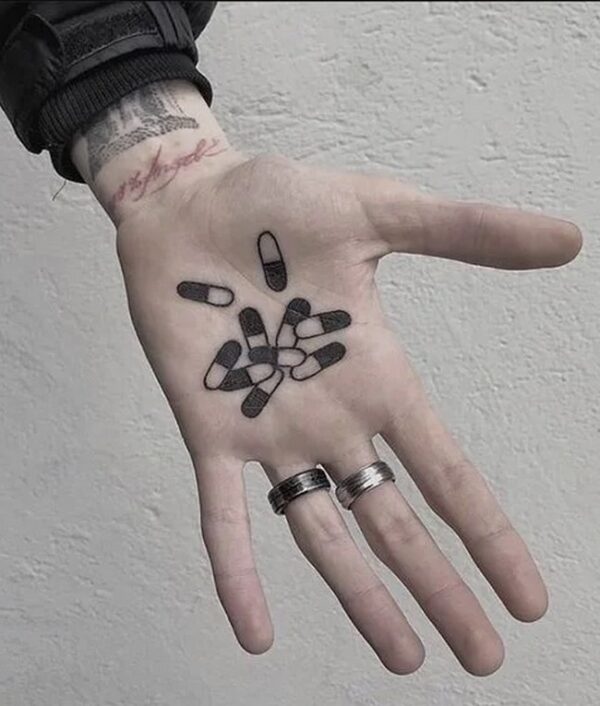 Capsules Tattoo On Palm