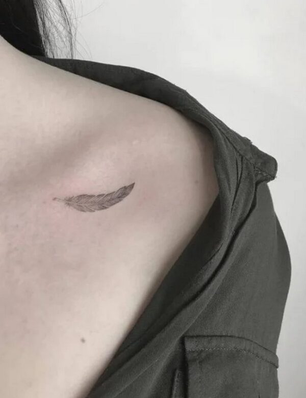 Discreet Feather Tattoo On Collarbone